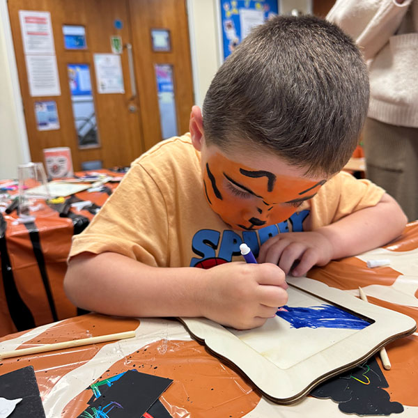 A boy doing craft activity in a library