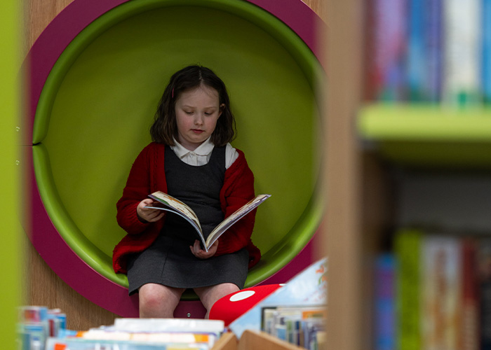 A girl reading at a library