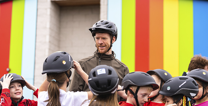 Ed Clancy OBE with children getting ready for riding a bike
