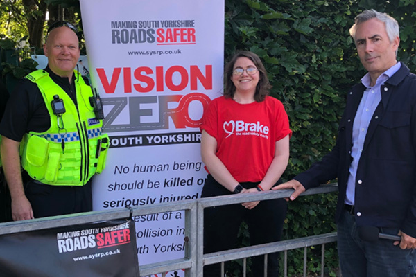 SYSR Partners beside a ‘Vision Zero South Yorkshire’ road safety sign.