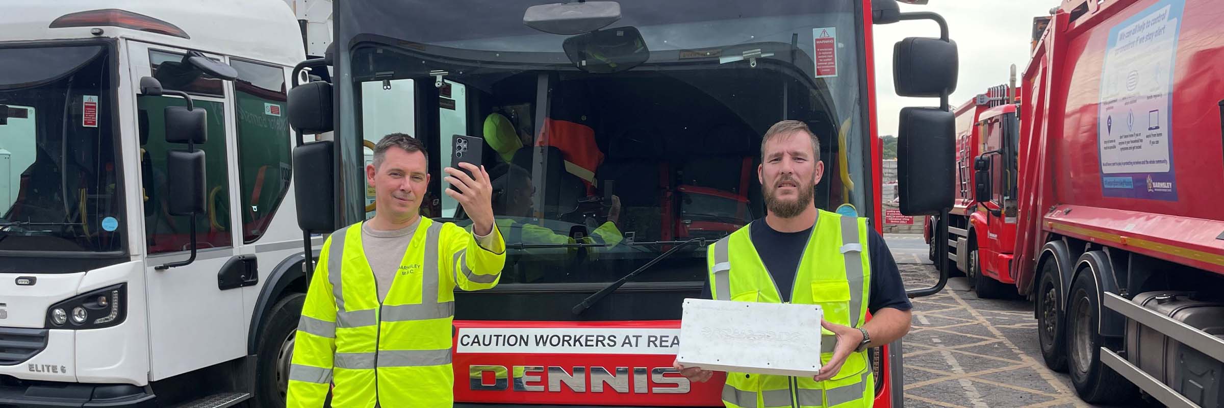 Two men standing in front of Bin Lorries