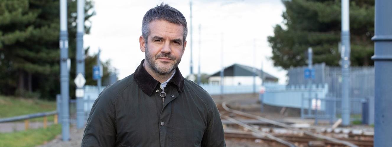 Image of Mayor Oliver on tram tracks