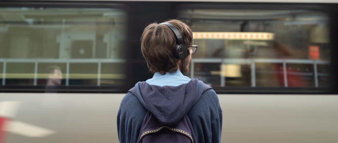 Man stood next to moving train