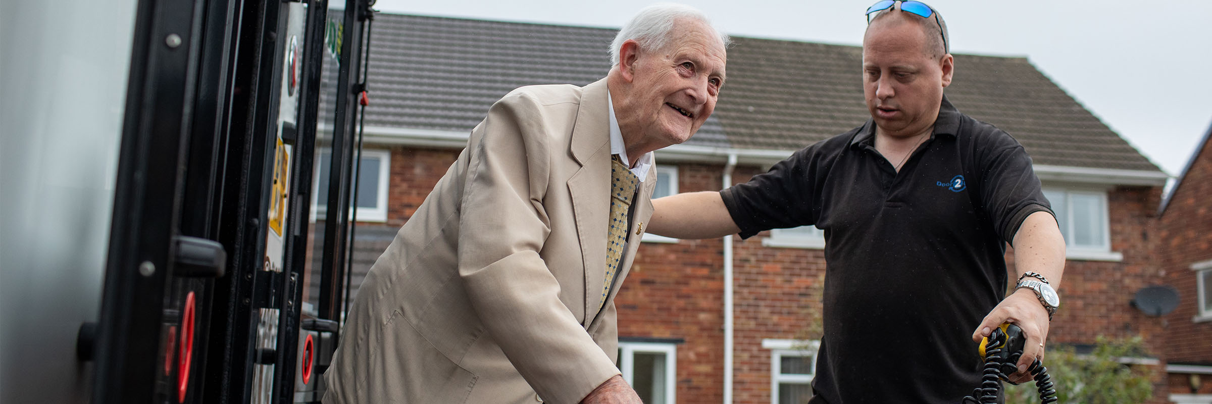 A volunteer driver helping a senior citizen 