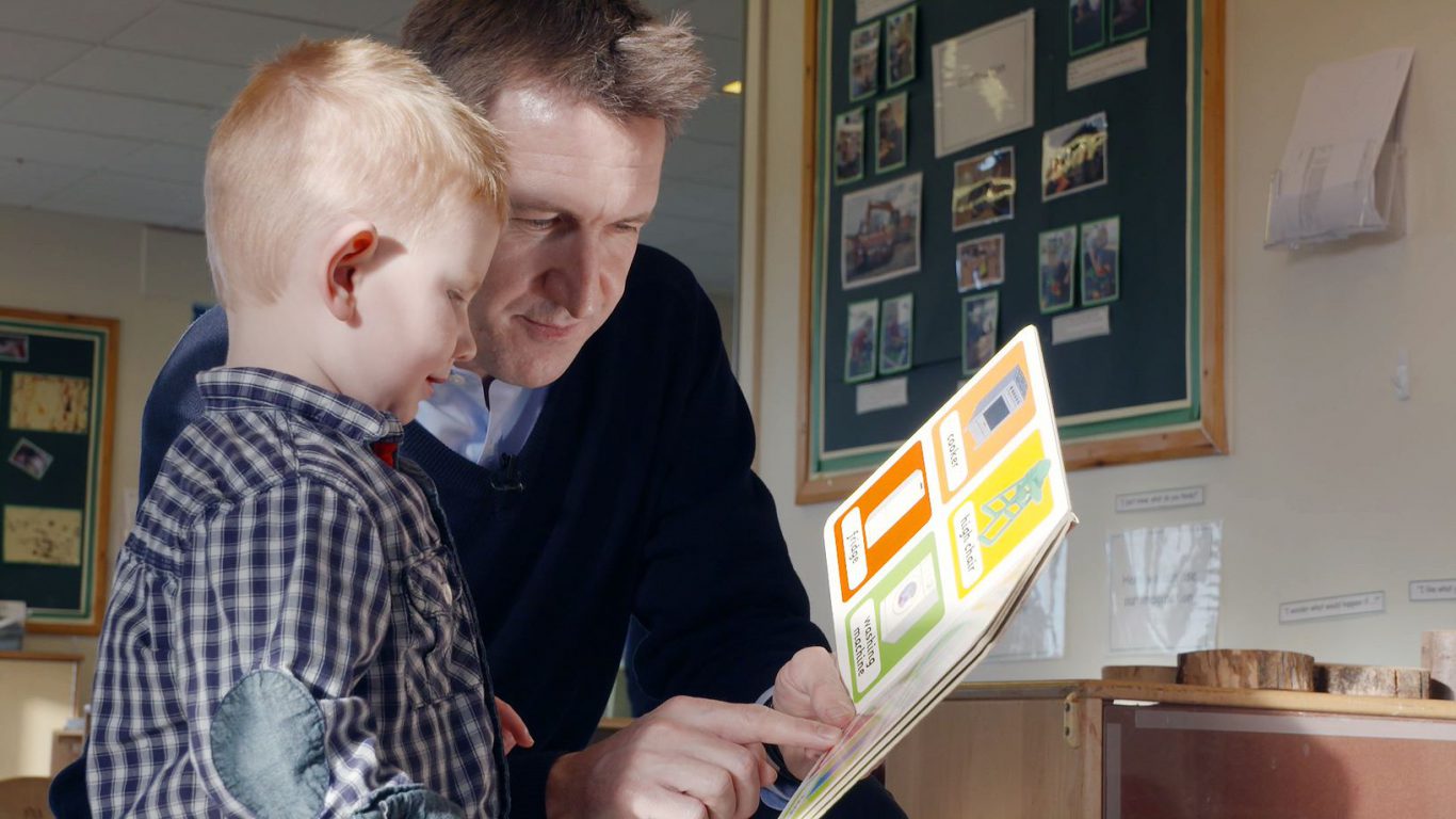 Dan Jarvis reads picture book with child