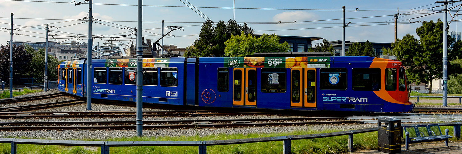 Blue, Orange and Red Tram travelling in South Yorkshire