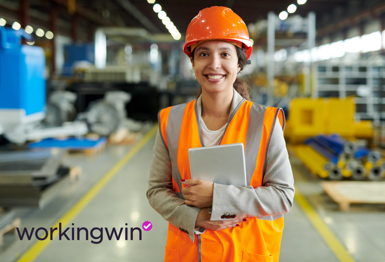A factory worker smiles for the camera